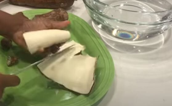 Peeling the cassava root for tapioca production