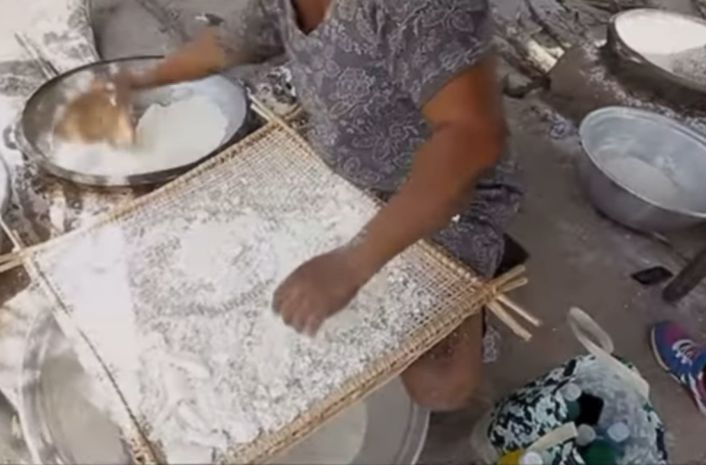 A woman locally processing cassava