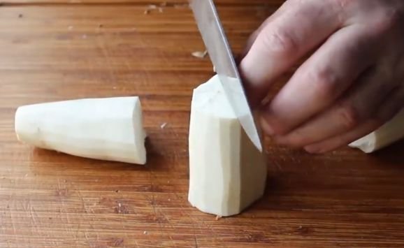 Yuca roots being chopped for frying