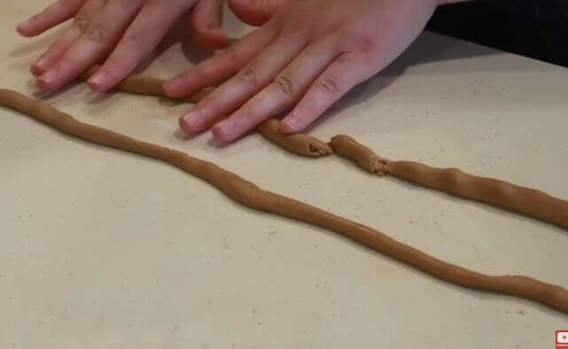 Rolling the rice starch dough into long logs before cutting