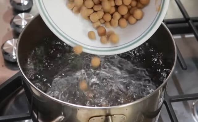 Adding the rolled rice boba dough into the boiling water