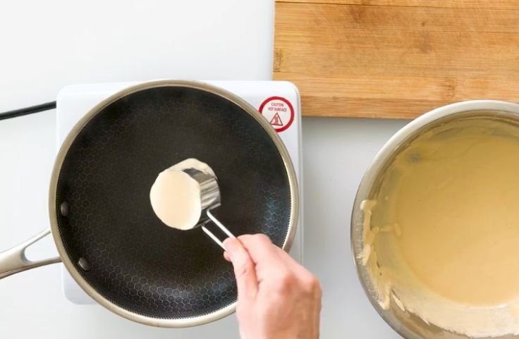 Pouring and cooking the cassava flour pancakes