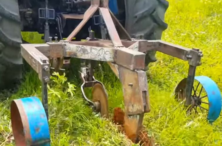A modern cassava harvesting machine at work