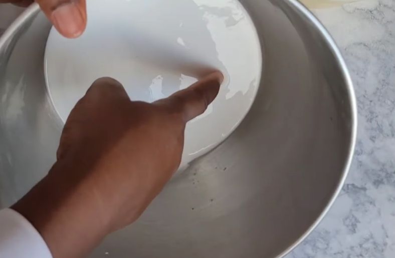 Decant or remove water from the settled starch