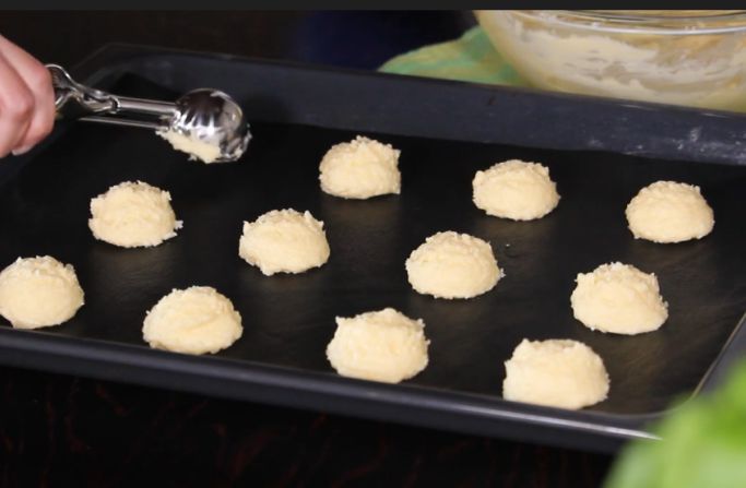 Dough for Pão de Queijo arranged in oven pan