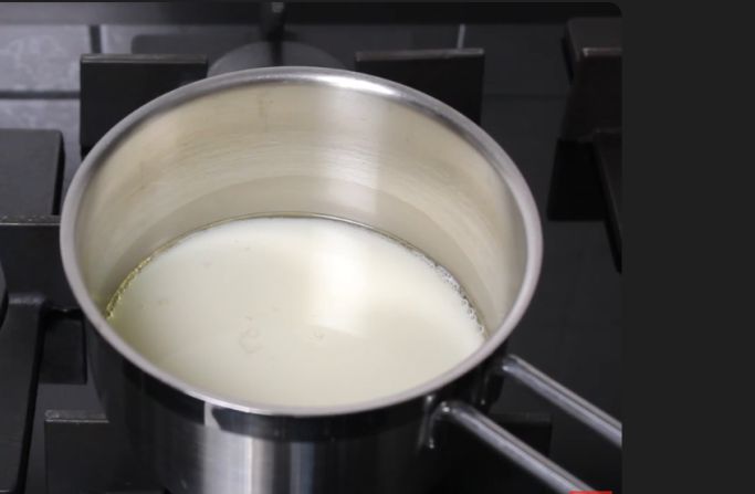 Heating the pan with milk to prepare the dough