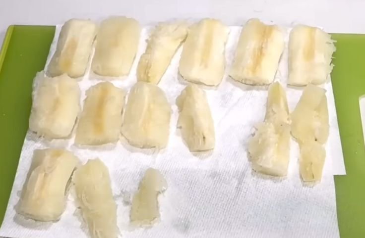 Draining the boiled cassava roots before air-frying
