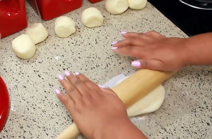 Flattening the cut dough with a pin or roller
