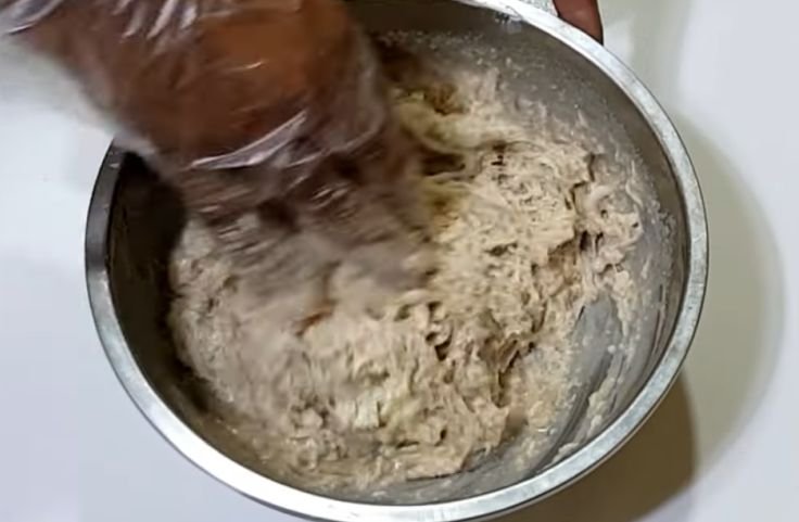 Mixing the grated cassava with ingredients