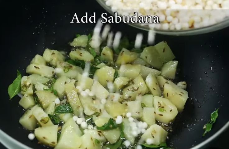 Adding sabudana to the potatoe and spices heating up