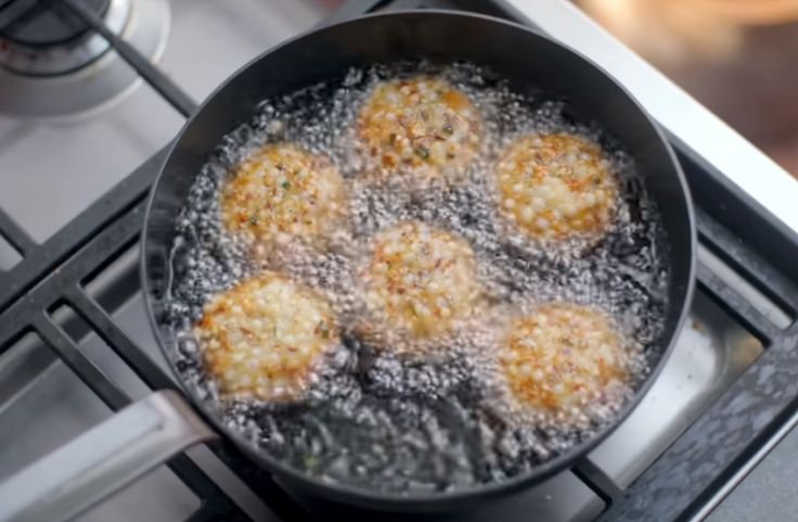 Frying sabudana vada until golden